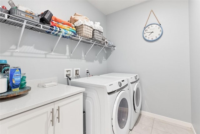 washroom featuring washer and dryer, baseboards, and light tile patterned flooring