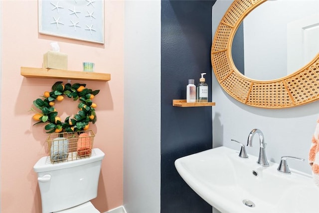 half bath featuring a sink and toilet