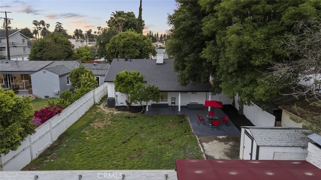 aerial view at dusk featuring a residential view