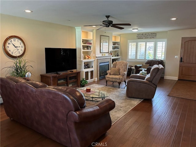 600 Morro Bay Blvd Unit 302, Morro Bay, CA 93442 - living room with ceiling fan, built in features, baseboards, dark wood-style floors, and a glass covered fireplace