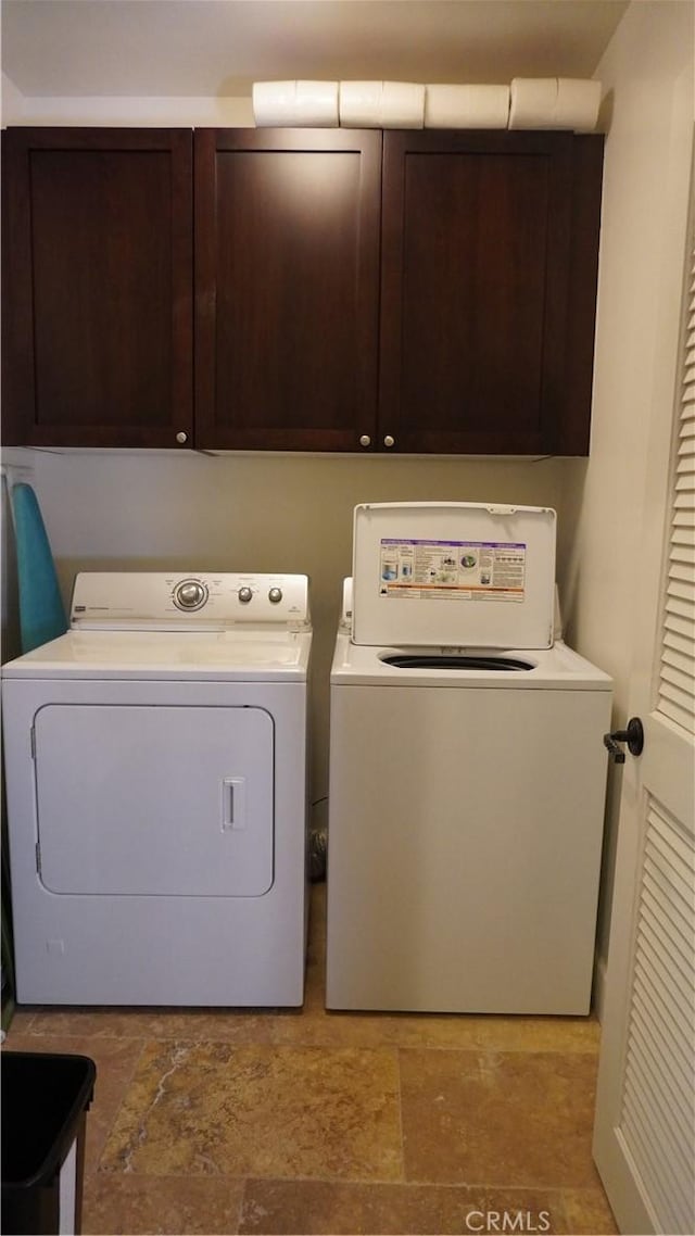 600 Morro Bay Blvd Unit 302, Morro Bay, CA 93442 - washroom featuring stone finish flooring, cabinet space, and washing machine and clothes dryer