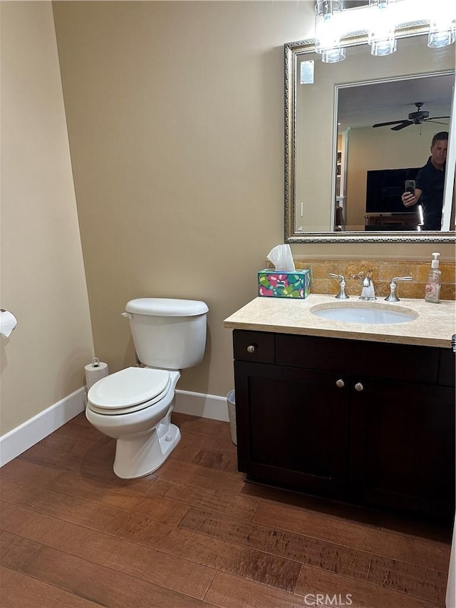 600 Morro Bay Blvd Unit 302, Morro Bay, CA 93442 - half bath featuring vanity, decorative backsplash, wood finished floors, toilet, and baseboards