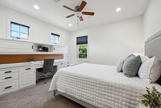 bedroom featuring recessed lighting, built in study area, and carpet