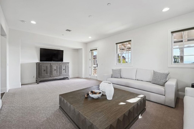 living area featuring recessed lighting, carpet flooring, baseboards, and visible vents