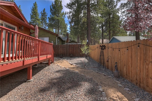 view of yard with a deck and a fenced backyard