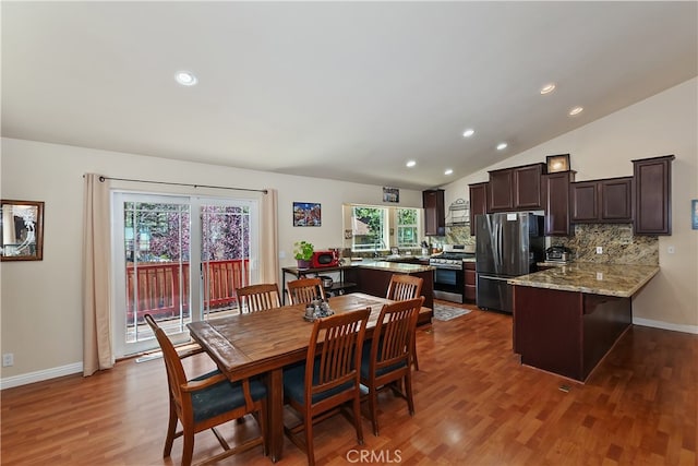 dining room featuring recessed lighting, baseboards, plenty of natural light, and wood finished floors