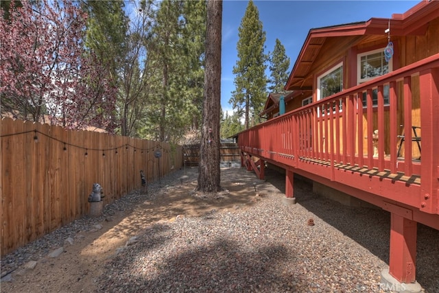 view of yard with fence and a wooden deck