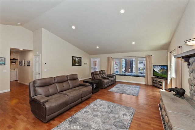 living room with high vaulted ceiling, baseboards, recessed lighting, and light wood-style flooring