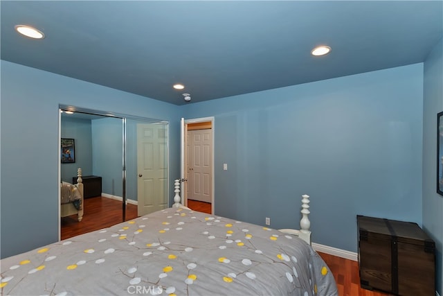 bedroom featuring baseboards, a closet, recessed lighting, and wood finished floors