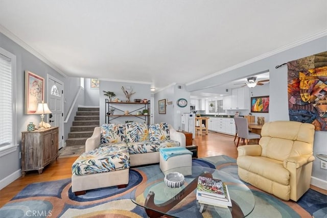 1585 Saratoga Ave, Grover Beach, CA 93433 - living room featuring light wood-type flooring, ornamental molding, stairway, a ceiling fan, and baseboards