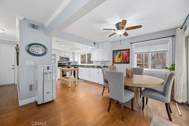 1585 Saratoga Ave, Grover Beach, CA 93433 - dining room with plenty of natural light, light wood-style floors, a ceiling fan, baseboards, and crown molding
