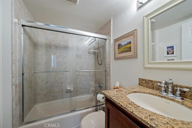 1585 Saratoga Ave, Grover Beach, CA 93433 - bathroom with toilet, bath / shower combo with glass door, vanity, and a textured ceiling