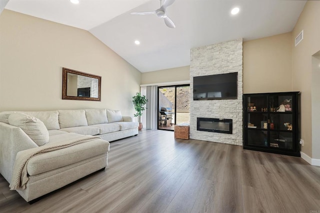 living area with ceiling fan, vaulted ceiling, wood finished floors, and visible vents
