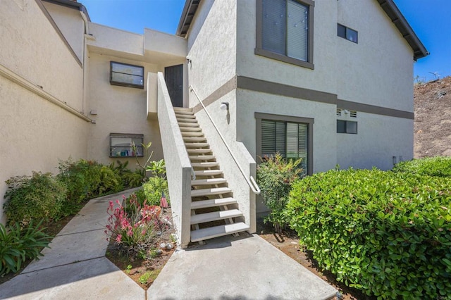 entrance to property with stucco siding