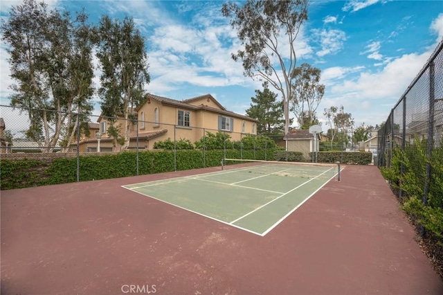 view of tennis court with fence