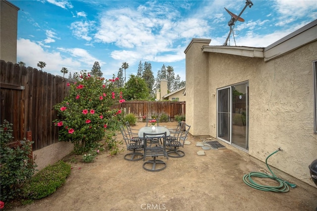 view of patio with a fenced backyard and outdoor dining space
