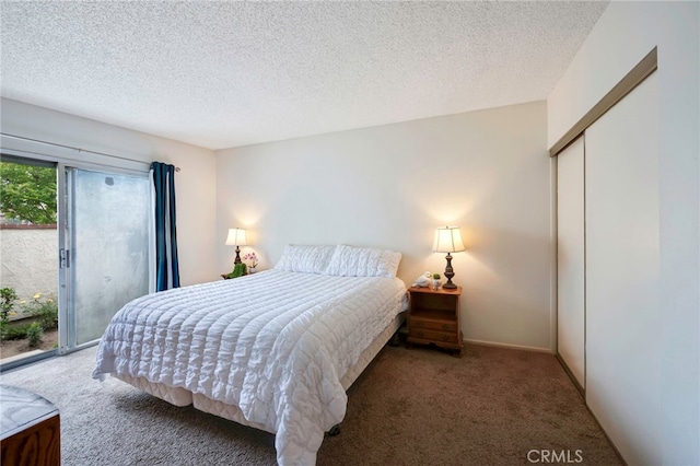 bedroom with a closet, carpet flooring, a textured ceiling, and access to exterior