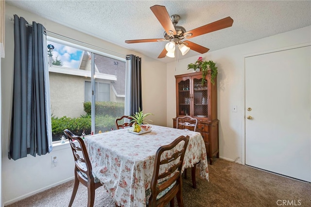 dining area with carpet floors, a textured ceiling, ceiling fan, and baseboards