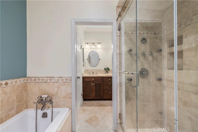 bathroom with a garden tub, a stall shower, and vanity