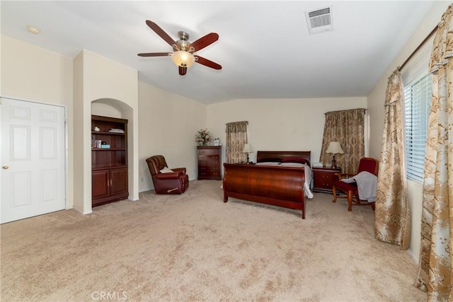 bedroom featuring visible vents, carpet, ceiling fan, and vaulted ceiling