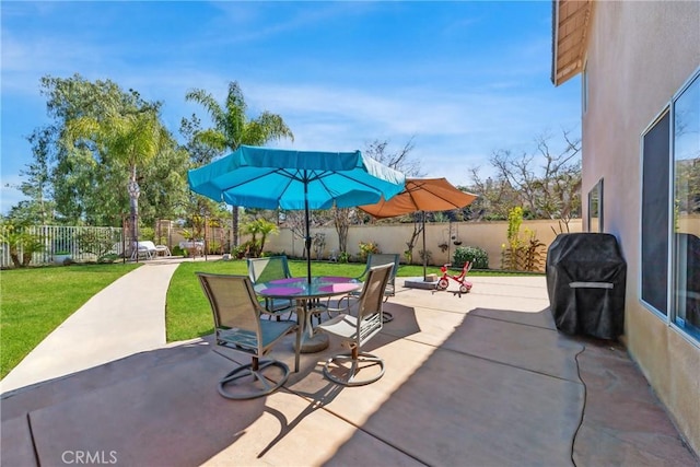 view of patio with a fenced backyard, outdoor dining space, and area for grilling