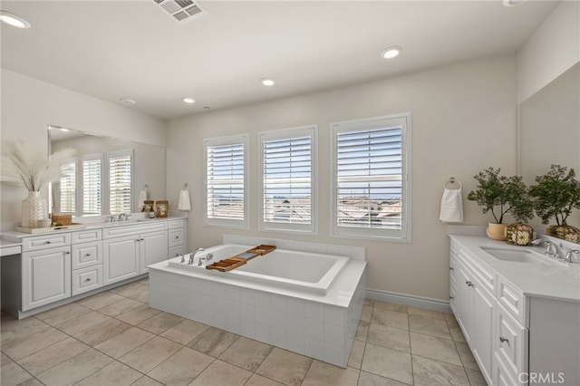 1776 Canyon Oaks Ln, Lake Forest, CA 92610 - bathroom featuring two vanities, a bath, recessed lighting, tile patterned flooring, and baseboards