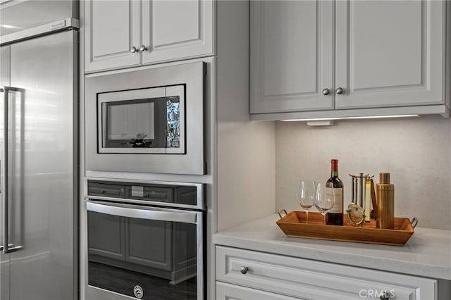 1776 Canyon Oaks Ln, Lake Forest, CA 92610 - kitchen featuring appliances with stainless steel finishes, white cabinets, and light countertops