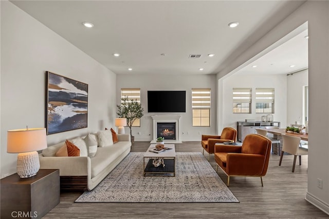 1776 Canyon Oaks Ln, Lake Forest, CA 92610 - living area featuring wood finished floors, a glass covered fireplace, baseboards, and recessed lighting
