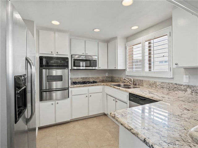 4301 Fulton Ave Unit 303, Sherman Oaks, CA 91423 - kitchen featuring appliances with stainless steel finishes, a warming drawer, white cabinetry, a sink, and light tile patterned flooring