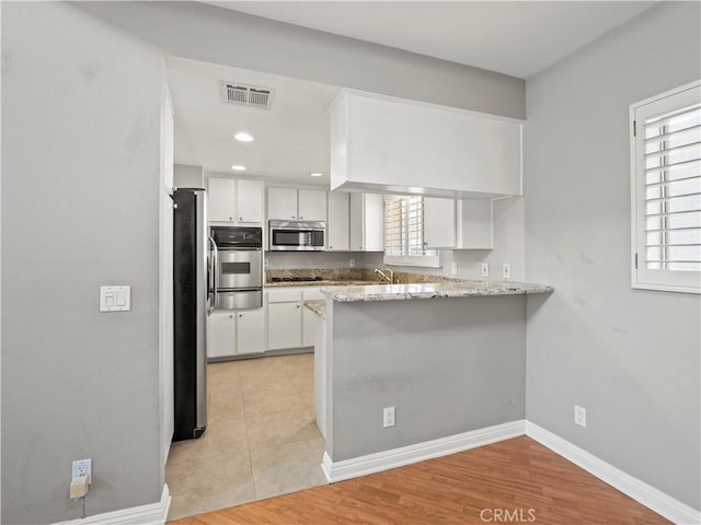 4301 Fulton Ave Unit 303, Sherman Oaks, CA 91423 - kitchen with stainless steel appliances, a peninsula, a warming drawer, white cabinets, and recessed lighting