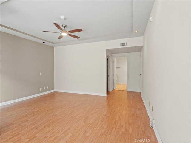 4301 Fulton Ave Unit 303, Sherman Oaks, CA 91423 - spare room featuring a ceiling fan, light wood finished floors, a tray ceiling, and baseboards