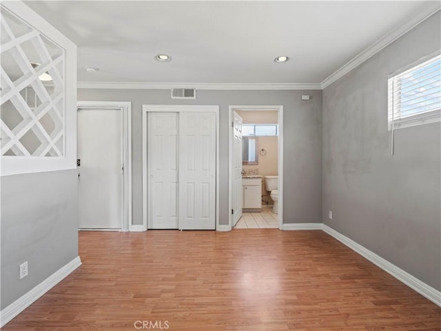 4301 Fulton Ave Unit 303, Sherman Oaks, CA 91423 - unfurnished bedroom with ornamental molding, multiple windows, light wood-style floors, baseboards, and multiple closets