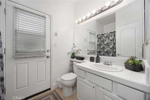 bathroom with tile patterned floors, vanity, and toilet