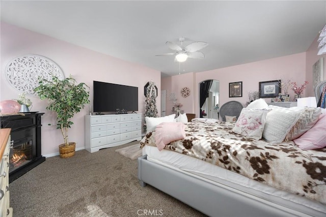 carpeted bedroom featuring baseboards and ceiling fan