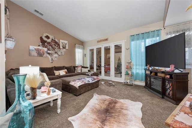 carpeted living room featuring visible vents, lofted ceiling, and french doors