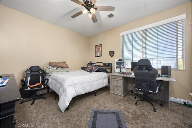 carpeted bedroom featuring ceiling fan and visible vents