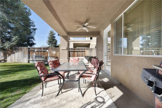 view of patio with a fenced backyard, outdoor dining space, and ceiling fan