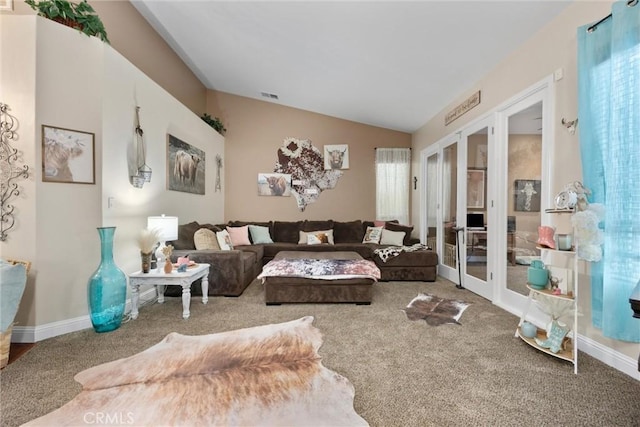 carpeted living area with vaulted ceiling, baseboards, french doors, and visible vents