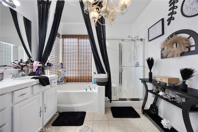 full bathroom featuring an inviting chandelier, a garden tub, vanity, tile patterned floors, and a shower stall