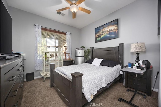 carpeted bedroom with a ceiling fan, baseboards, and visible vents