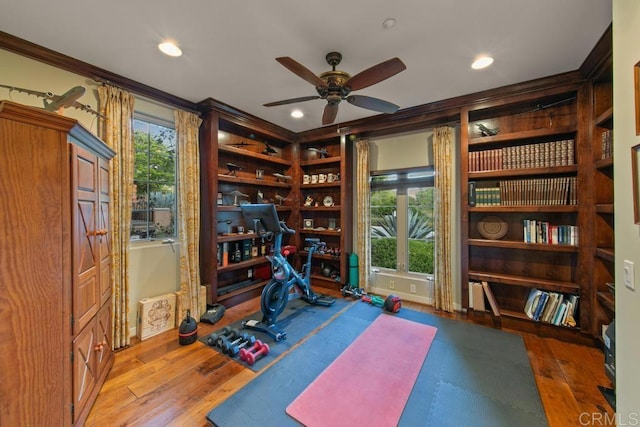 exercise area with crown molding, recessed lighting, ceiling fan, and hardwood / wood-style flooring