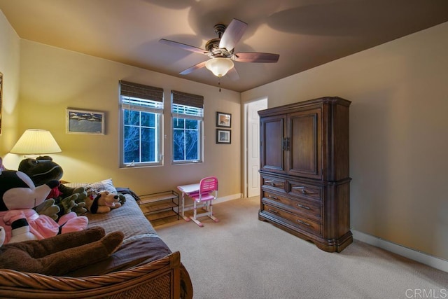 bedroom featuring baseboards, ceiling fan, and light colored carpet