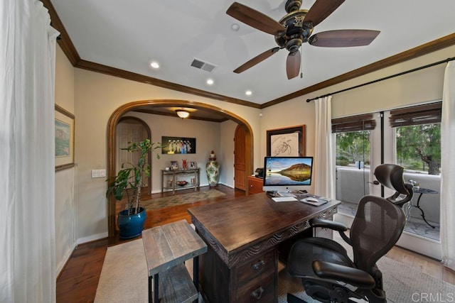 office with ceiling fan, arched walkways, baseboards, wood finished floors, and ornamental molding