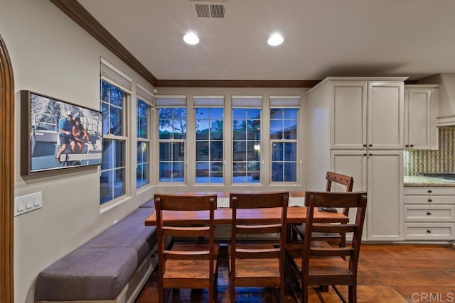 dining room featuring crown molding, recessed lighting, visible vents, and dark wood-type flooring