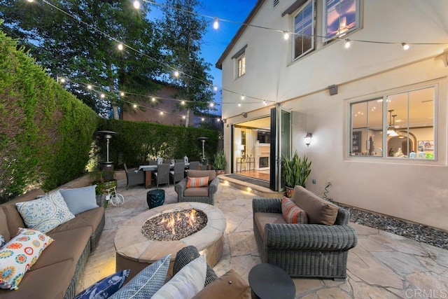 view of patio with an outdoor living space with a fire pit and outdoor dining space