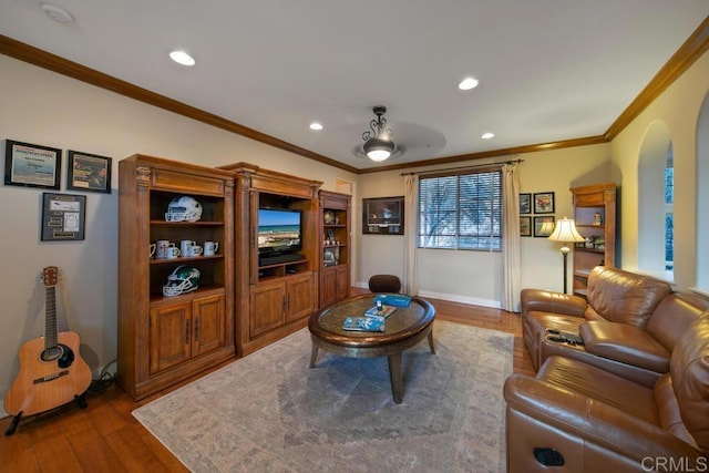 living room featuring baseboards, ornamental molding, recessed lighting, and wood finished floors