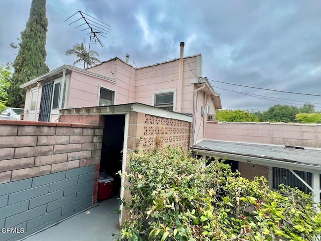 view of property exterior featuring fence