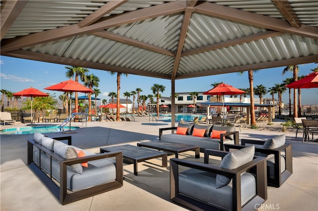view of home's community featuring a swimming pool, a patio area, and an outdoor hangout area