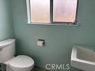 half bath with toilet and a sink