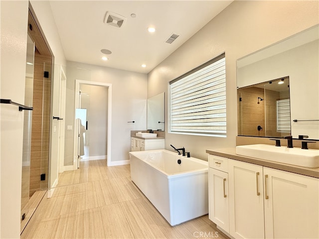 full bathroom with visible vents, a shower stall, and a sink